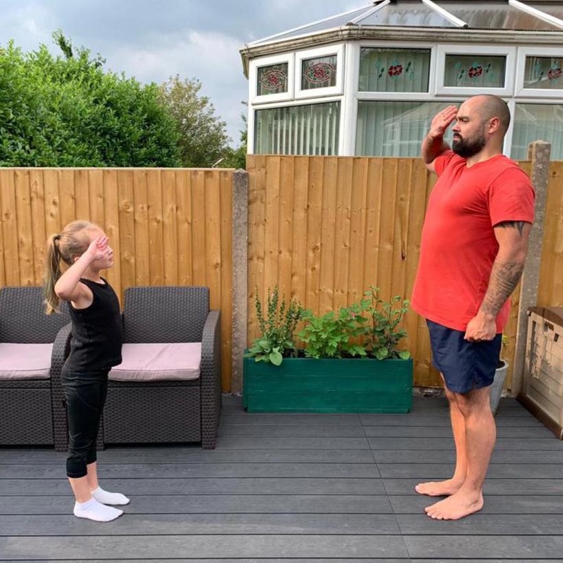 Jonathan teaching his daughter to salute