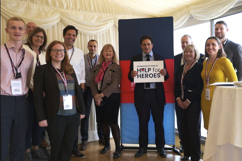 Johnny Mercer with with Help for Heroes staff holding placard