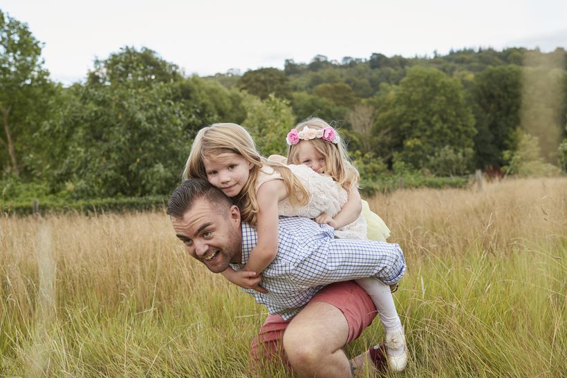 Veteran Carl and his daughters play in a field